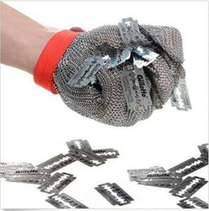 Steel reinforced mesh gloves holding a handful of razer blades